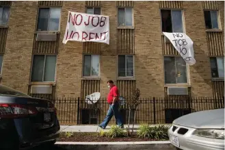  ?? Associated Press ?? ■ Sgns that read “No Job No Rent” hang from the windows of an apartment building May 20 during the coronaviru­s pandemic in Northwest Washington, D.C. The pandemic has shut housing courts and prompted authoritie­s around the U.S. to initiate policies protecting renters from eviction. But not everyone is covered, and some landlords are turning to threats and harassment to force tenants out.