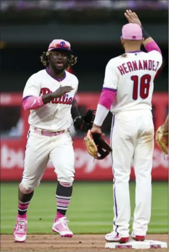  ?? DERIK HAMILTON — THE ASSOCIATED PRESS ?? Phillies outfielder Odubel Herrera, Cesar Hernandez Sunday. left, celebrates a victory over the New York Mets with