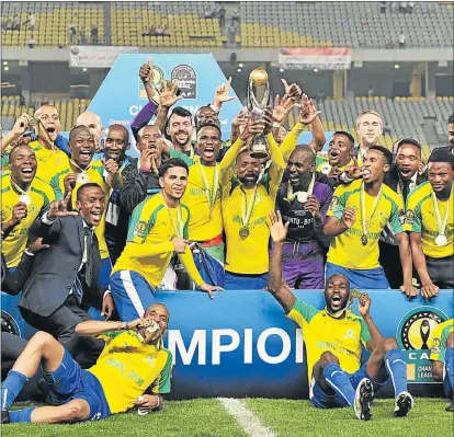  ?? Picture: BACKPAGEPI­X ?? FEELING GOOD: Mamelodi Sundowns celebrate with the trophy after winning the Caf Champions League final 3-1 on aggregate against Zamalek at the El Borg Arab Stadium in Alexandria, Egypt, last night