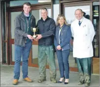  ??  ?? Winner of the Stirling show of store cattle, Allan McArthur, Cretlevane, being presented with the trophy by the judge William Moir, Cairness. Also in the photograph Lynda Graham from the sponsors Rural Finance and George Purves, MD, United Auctions.