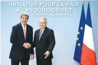  ?? (Reuters) ?? US SECRETARY of State John Kerry and French Foreign Minister Jean-Marc Ayrault shake hands in Paris on Friday.