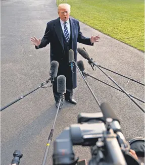  ?? ANDREW HARNIK/AP ?? President Trump talks to reporters Saturday outside the White House before boarding Marine One, en route to New York for fundraiser­s.