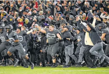  ?? Patrick Semansky / Associated Press ?? Army players celebrate in 2016 after snapping a 14-game losing skid to Navy. Army, which will face Houston in the Armed Forces Bowl, looks to make it three straight over its biggest rival.