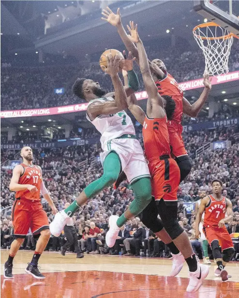  ?? CHRIS YOUNG / THE CANADIAN PRESS ?? Boston’s Jaylen Brown shoots on Raptors OG Anunoby, centre, and Serge Ibaka in Tuesday night’s game.