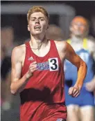  ?? DOUG MCSCHOOLER/FOR INDYSTAR ?? Martinsvil­le’s Martin Barco crosses the finish line to win the Flashes Showcase Miracle Mile race on April 14, 2023, at Franklin Central High School.