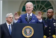  ?? (AP/Susan Walsh) ?? President Joe Biden speaks Friday in the Rose Garden of the White House in Washington during an event to highlight state and local leaders who are investing in American Rescue Plan funding. Attorney General Merrick Garland (left) and Kansas City, Mo., Police Department Police Chief Joe Mabin listen.