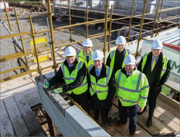  ??  ?? Minister for state Paul Kehoe performs the ‘Topping Out’ ceremony at the site of the new Loreto school yesterday (Monday). Also pictured are MIchael Sammon (Sammon Group), Dermot O’Reilly (Inspired Spaces), Sean Court (NDFA), Michael O’Reilly (Sammon...