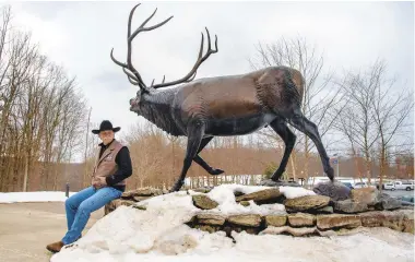  ??  ?? Left: Rawley Cogan, President and CEO and co-founder of the Keystone Elk Country Alliance, poses at the elk sculpture in front of the Elk County Visitor Center in Benezette.