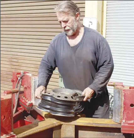  ?? CODY mCEACHERN/tRuRO DAILY NEWs ?? While most wheel crushing machines depend on one arm crushing the rim in half, Wayne Smith’s system uses a threearm setup, making the machine more efficient, and cutting the crushing process in half. The machine is built on a trailer, making it...