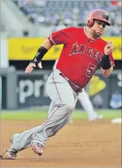  ?? Ed Zurga Getty Images ?? KOLE CALHOUN rounds third base on the way to score on a first-inning single by Albert Pujols.