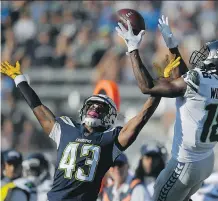  ?? MARK J. TERRILL/THE ASSOCIATED PRESS ?? Seattle Seahawks wide receiver Kasen Williams goes up for a catch over Los Angeles Chargers cornerback Michael Davis during Sunday’s NFL preseason game in Carson, Calif.