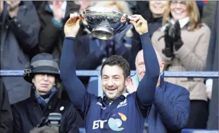  ?? ANDY BUCHANAN/AFP ?? Scotland captain Greig Laidlaw lifts the Centenary Quaich after beating Ireland in the Six Nations at Murrayfiel­d in Edinburgh on Saturday. A is a Celtic drinking vessel.