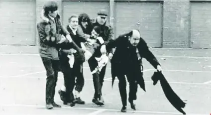  ?? (Courtesy) ?? THE FAMOUS picture taken on ‘Bloody Sunday,’ January 30, 1972, shows priest Edward Daly waving a bloodstain­ed handkerchi­ef at British troops. Daly died on Monday at age 82.