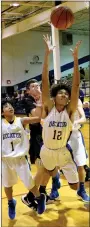  ?? Westside Eagle Observer/MIKE ECKELS ?? Tafari James (Decatur 12) fights hard to reach a loose ball during the Decatur-Mulberry basketball contest at Peterson Gym in Decatur Nov. 26. The Yellowjack­ets defeated the Bulldogs in the first round of the Decatur Holiday Hoops Tournament.