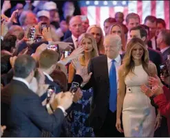  ?? AP/MARY ALTAFFER ?? Donald Trump arrives for a news conference Tuesday at Trump Tower in New York with his wife, Melania (right), and daughter Ivanka.