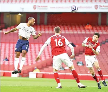  ?? - AFP photo ?? Sterling (left) jumps to head home the opening goal.