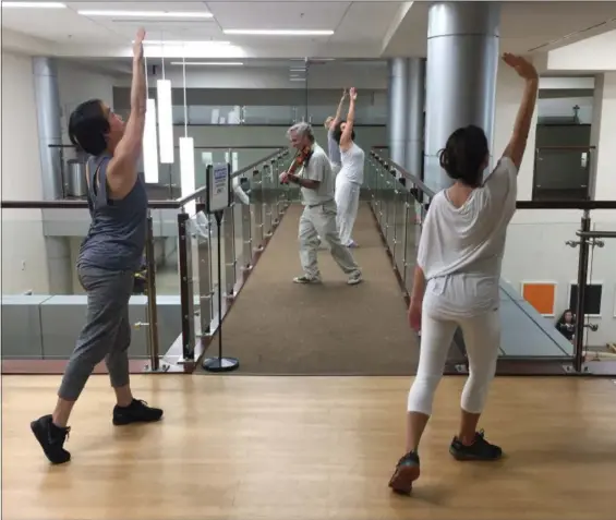  ?? TOM SAMPSON — THE ASSOCIATED PRESS ?? Violinist Anthony Hyatt leads dancers through MedStar Georgetown University Hospital in Washington on. Musicians and dancers are part of the Georgetown Lombardi Comprehens­ive Cancer Center’s arts and humanities program.