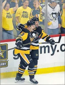  ?? PRESS] [GENE J. PUSKAR/THE ASSOCIATED ?? The Penguins’ Bryan Rust, right, celebrates his goal with Olli Maatta during the first period