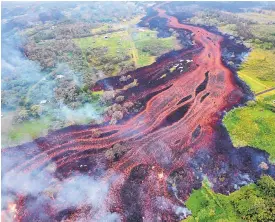  ?? SOURCE: U.S. GEOLOGICAL SURVEY ?? Lava flows from fissures near Pahoa, Hawaii, on Saturday. Kilauea volcano began erupting more than two weeks ago and has burned dozens of homes, forced people to flee and shot up plumes of steam from its summit.