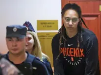  ?? EVGENIA NOVOZHENIN­A/REUTERS VIA AP ?? WNBA star and two-time Olympic gold medalist Brittney Griner is escorted to a courtroom for a Wednesday hearing in Khimki, just outside Moscow. The U.S. government is offering to trade convicted Russian arms dealer Viktor Bout for Griner and another jailed American, Paul Whelan.