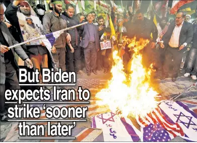  ?? ?? HEATED HATE: Iranians burn Israeli and US flags during a protest in Tehran on April 1 after Syrian and Iranian officials said Israeli airstrikes destroyed the Iranian Embassy’s consular annex in Damascus.