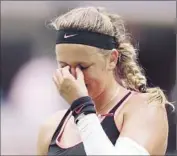  ?? Mike Stobe Getty Images ?? VICTORIA AZARENKA reacts during her 6-3, 4-6, 6-4 loss, which had a momentum-shifting rain delay.