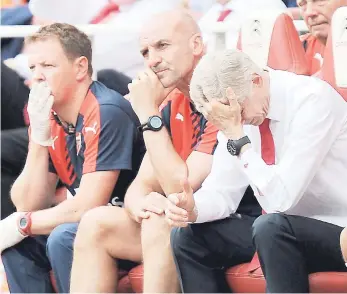  ??  ?? Arsenal manager Arsene Wenger (right) puts his hand to his head during the English Premier League match against West Ham United at the Emirates Stadium in London yesterday. Arsenal lost their first match of the new season 2-0.