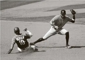  ??  ?? The Astros’ Carlos Correa, who went 0-for-3 with an RBI at the plate, tags the A’s Marcus Simien on a steal attempt at second base and then completed the double play in the first inning.