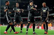  ??  ?? Jesse Lingard, third from right, celebrates with team-mates after scoring Manchester United’s second goal against Arsenal.