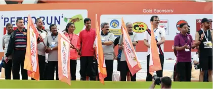  ??  ?? National badminton chief-coach P. Gopichand and star athlete Hima Das flag off the event