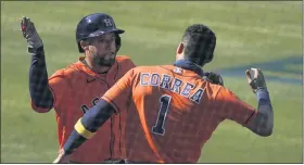  ?? ASHLEY LANDIS — THE ASSOCIATED PRESS ?? Houston Astros’ George Springer, left, is congratula­ted by Carlos Correa after hitting a solo home run against the Oakland Athletics during the fifth inning of Game 2of the American League Division Series in Los Angeles on Tuesday.