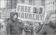  ?? Omer Messinger/getty Images Europe/tns ?? Protesters hold a banner reading “FREE NAVALNY” as some 2,500 supporters of Russian opposition politician Alexei Navalny march in protest to demand his release from prison in Moscow on Jan. 23 in Berlin, Germany.