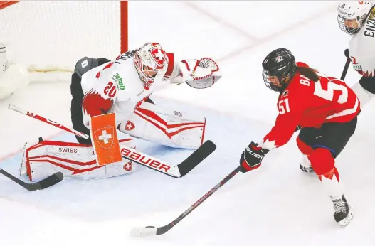 ?? PHOTOS: DARREN MAKOWICHUK ?? Canada's Victoria Bach and her teammates were too much for the Swiss in the IIHF semifinals, posting a 4-0 shutout Monday night at Winsport Arena in Calgary.