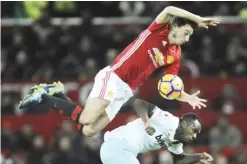  ??  ?? MANCHESTER: Manchester United’s Matteo Darmian, top, and West Ham’s Michail Antonio battle for the ball during the English Premier League soccer match between Manchester United and West Ham United at Old Trafford in Manchester, England, yesterday. —AP