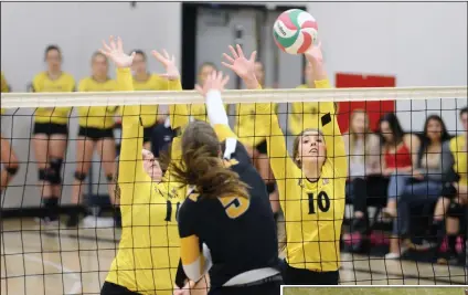  ?? NEWS PHOTOS RYAN MCCRACKEN ?? (Left) Medicine Hat Rattlers Mckenzie Griffith (10) and Jennifer Saj block a hit from Journey Flewell (5) of the Ambrose Lions during Saturday’s Alberta Colleges Athletic Conference women’s volleyball match at the Snake Pit. (Below) Medicine Hat Rattlers midfielder Ardita Zejnullahu hits a shot on the volley during the second half of Saturday’s Alberta Colleges Athletic Conference women’s soccer match at the Snake Pit.