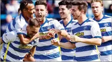  ??  ?? MERRY MORTON: Michael Tidser is mobbed by his jubilant team-mates after giving his side the lead from the penalty spot