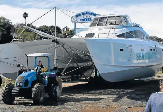  ?? Picture: LOUISE CARTER ?? BIGGEST BOAT: Dennis Schultz proudly pulls the 67 foot catamaran, Sea Chant, into the Port Alfred small boat harbour entrance on Saturday. Sea Chant took Super Cat Marine boat builder about 13 years to complete