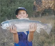  ?? COURTESY PHOTO ?? Jusiah Estrada, 11, of Las Vegas, New Mexico, caught a 26-inch rainbow trout using a Panther Martin spinner on the Gallinas River on Nov. 2. CIMARRÓN RIVER: