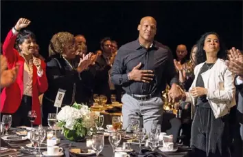  ?? Antonella Crescimben­i/Post-Gazette ?? Ryan Shazier stands up to an ovation with help from his fiancee, Michelle Rodriguez, after being acknowledg­ed by Steelers general manager Kevin Colbert. The recognitio­n came during the Dapper Dan Dinner &amp; Sports Auction on Feb. 21 at the David L. Lawrence Convention Center.