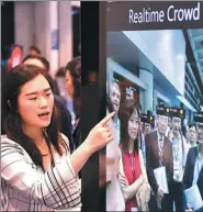  ?? CHINA NEWS SERVICE ?? A Microsoft employee introduces the company’s smart city solution product, based on big data and artificial intelligen­ce, during an exhibition in Hong Kong.