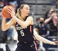  ?? Tyler Sizemore / Hearst Connecticu­t Media ?? UConn guard Paige Bueckers plays in the Huskies’ season-opening 95-80 win over Arkansas at the XL Center in Hartford on Nov. 14. Bueckers is looking at two months out following surgery on Monday.