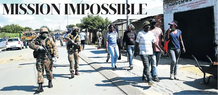  ?? Pictures: Thapelo Morebudi ?? Masked, gloved and armed soldiers patrol the streets of Diepsloot, north of Johannesbu­rg, where people are said to be ignoring many of the lockdown measures put in place to help slow infection rates in the Covid-19 pandemic.