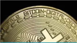  ?? — AFP ?? DORTMUND: In this file photo taken on Jan 26, 2020, a physical imitation of a bitcoin is pictured.