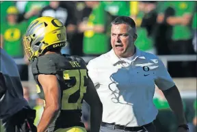  ??  ?? Under head coach Mario Cristobal, right, Oregon has held its first three conference opponents to under 10 points for the first time since 1933.