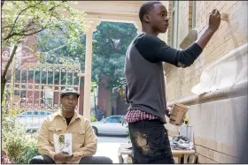  ??  ?? Aspiring artist Miles (Moonlight star Ashton Sanders) works on a mural as his mentor Robert McCall (Denzel Washington) looks on in Antoine Fuqua’s The Equalizer 2.