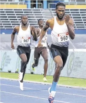  ?? (Photo: Dwayne Richards) ?? Anthony Cox (foreground) of Racers Track Club crosses the line to win the men’s 400m final in a personal best 45.75s at the Jubilee Series Meet at the National Stadium on Saturday, May 7, 2022. Dennick Luke (left) of GC Foster College was third in 47.66s, while Cox’s club teammate Terry Thomas was sixth in 47.26.