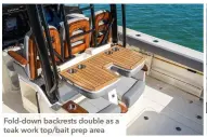  ?? ?? Fold-down backrests double as a teak work top/bait prep area