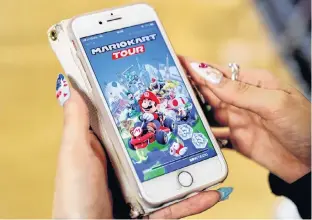  ?? KIM KYUNG-HOON/REUTERS ?? A woman shows the mobile title Mario Kart Tour on her smartphone during an interview with Reuters at Tatio’s game center in Tokyo, Japan, Wednesday.