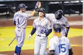  ?? MATT YORK/ASSOCIATED PRESS ?? Colorado’s Ryan McMahon (24), shown after his homer vs. Arizona last September, speculates facetiousl­y that shorter exhibition games can allow time for other pursuits.