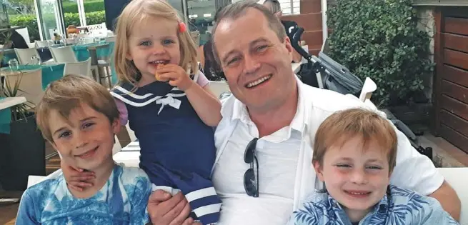  ??  ?? HEARTBREAK: The McGinley children — Conor (9), Carla (3) and Darragh (7) — with their father Andrew, in a photo released by the family